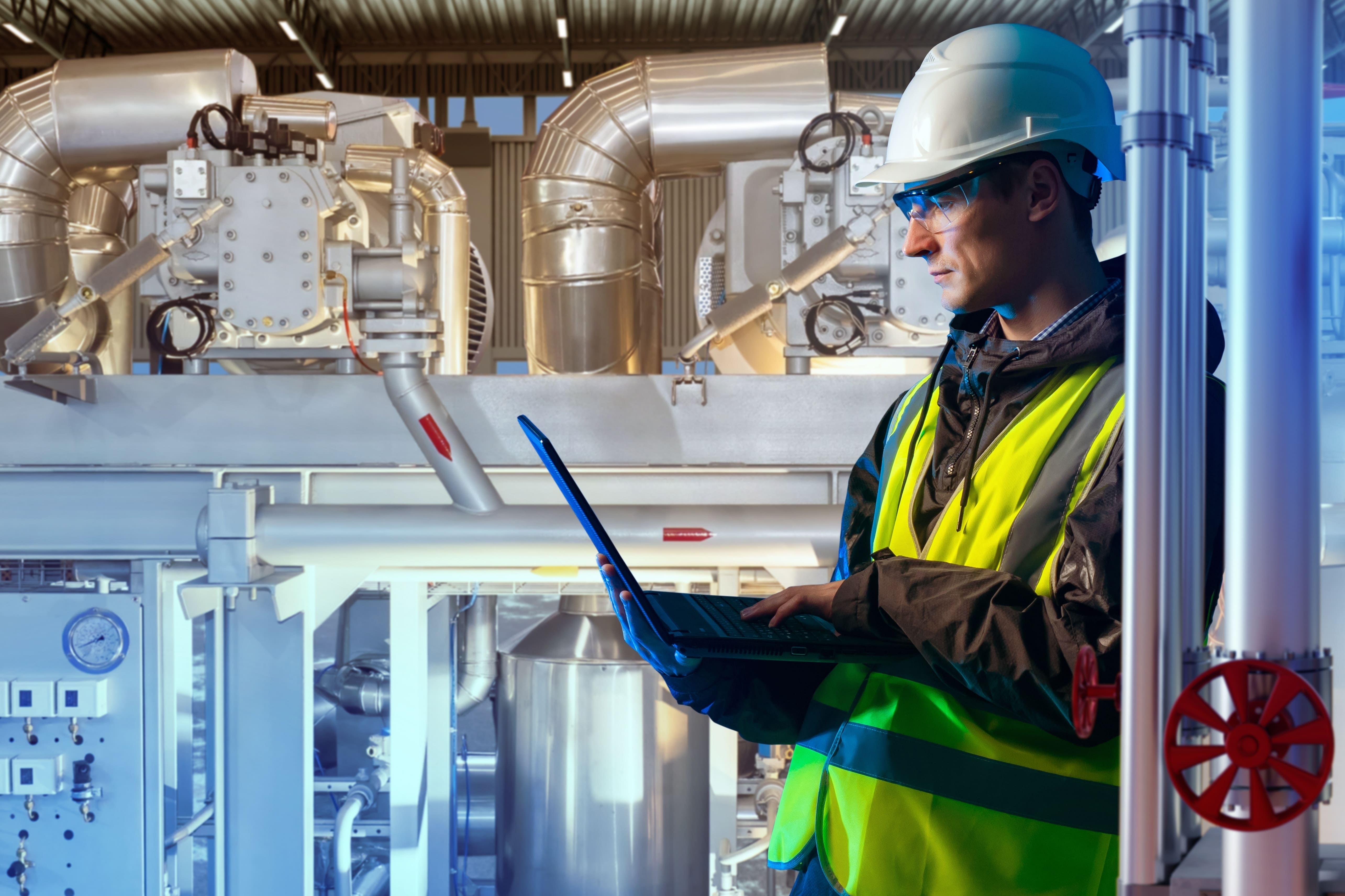 Manufacturing worker using EHS software in chemical processing center