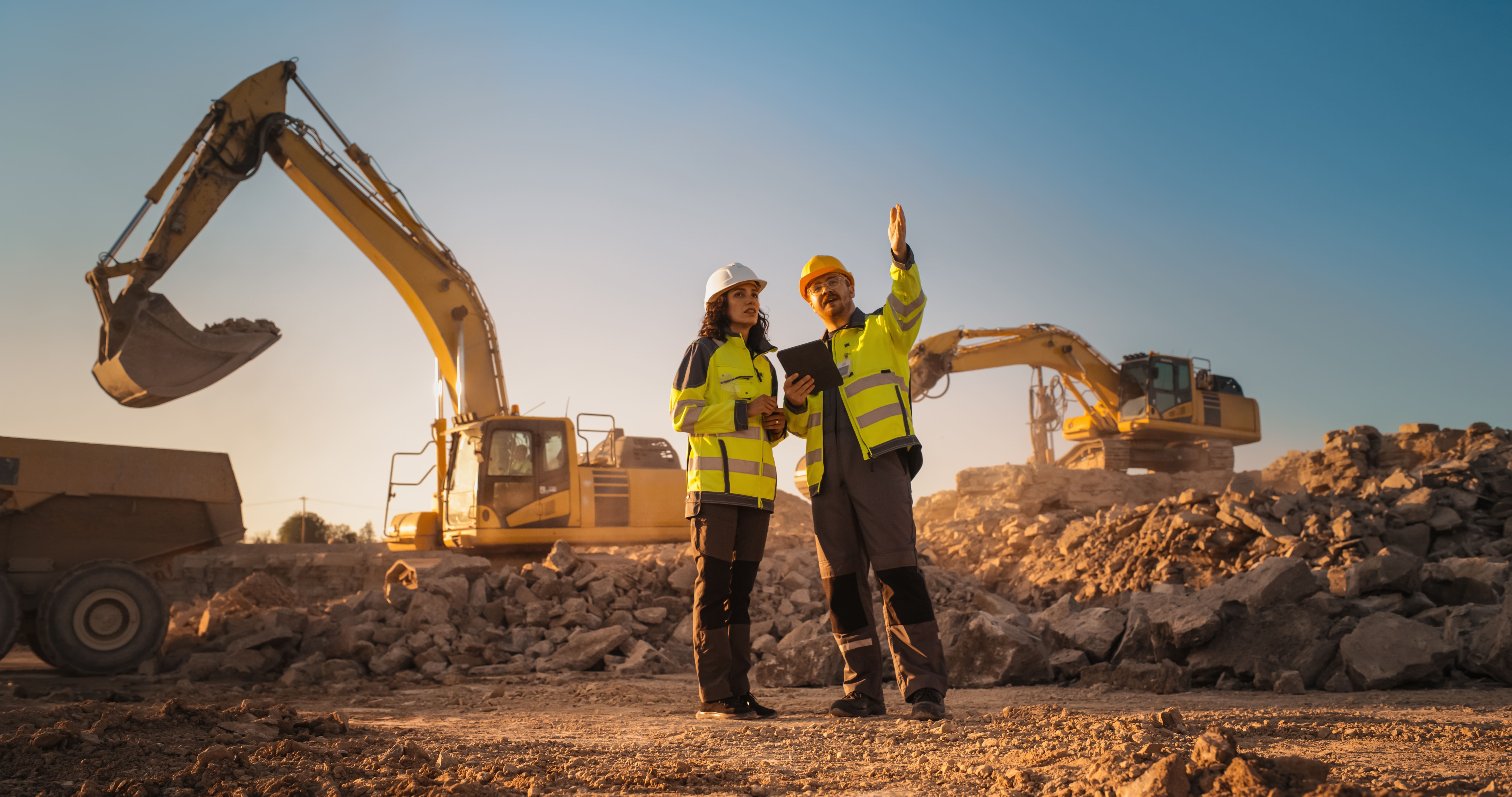 Male and female mining working at job site