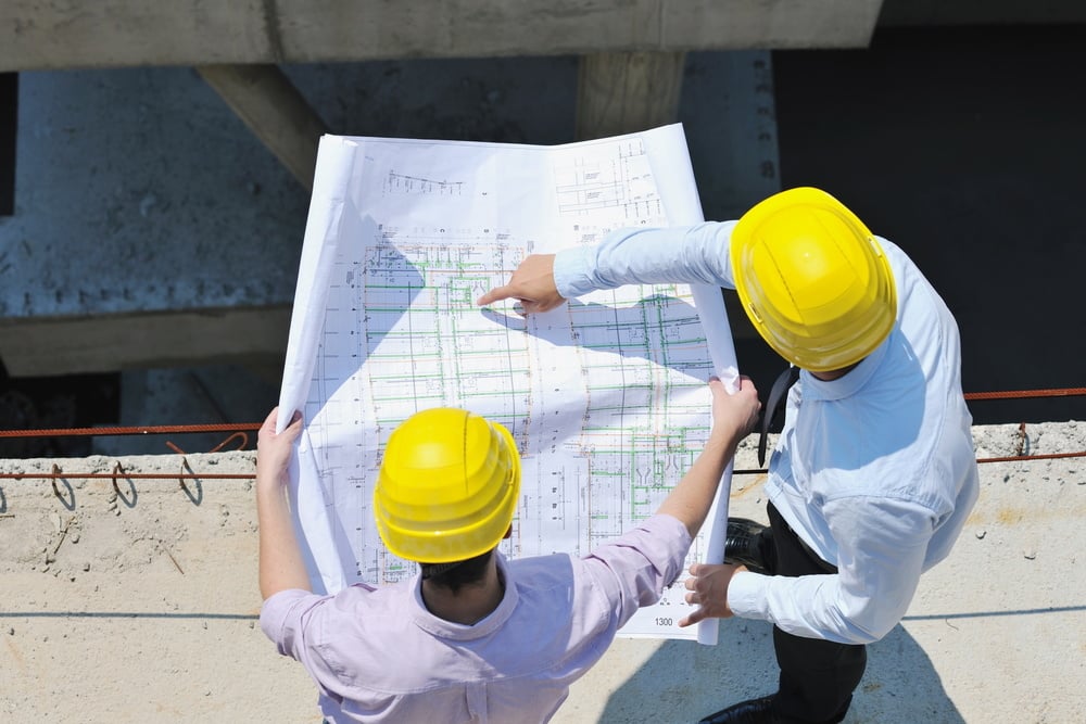 Team of architects people in group  on construciton site check documents and business workflow